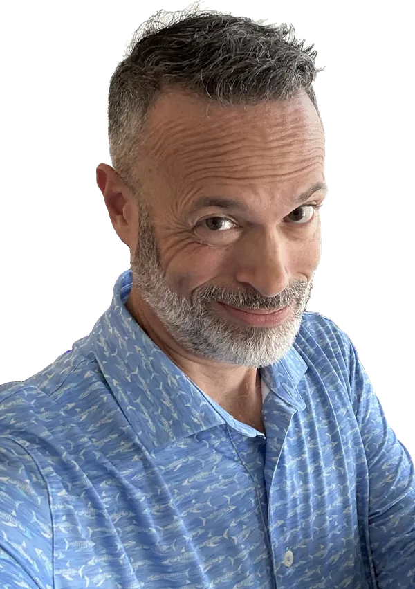 Adam LaBare, smiling, at his desk